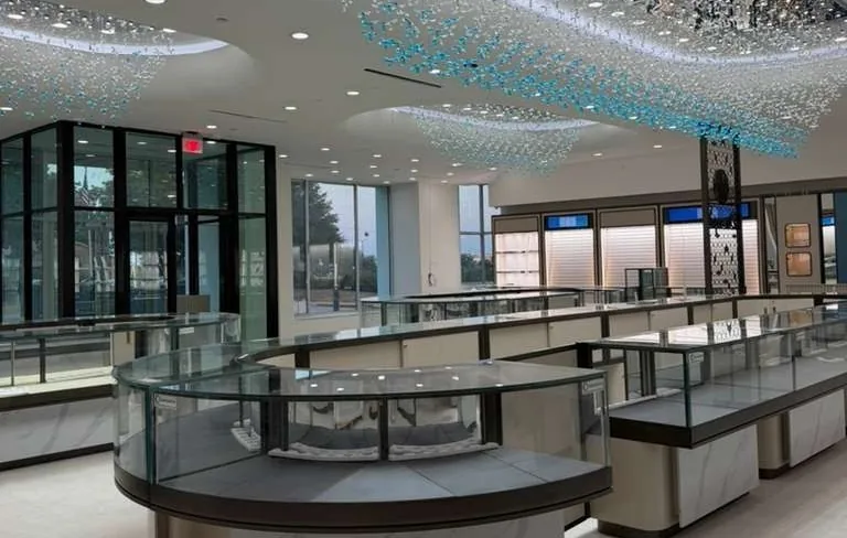 Finished jewelry showroom at 8820 John Hickman Parkway, Suite 100, with curved display cases under a crystal ceiling