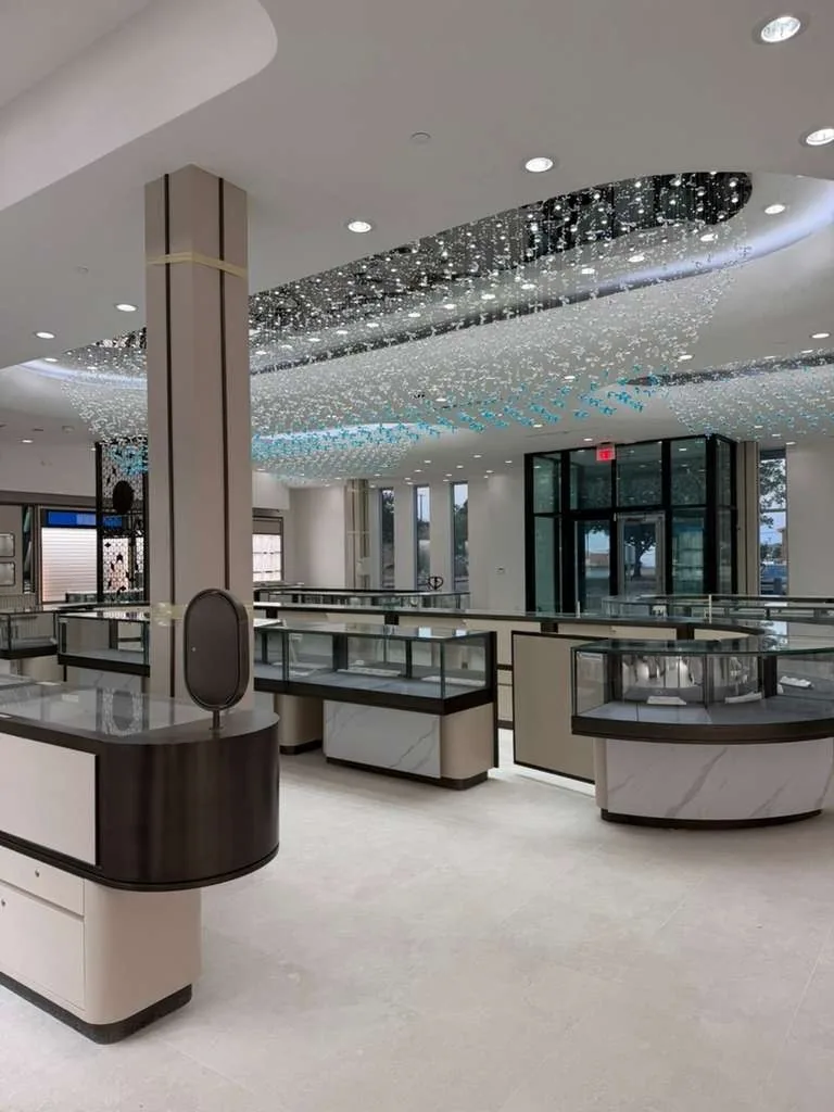 Showroom with display case runs and the bullet-resistant storefront glazing beyond
