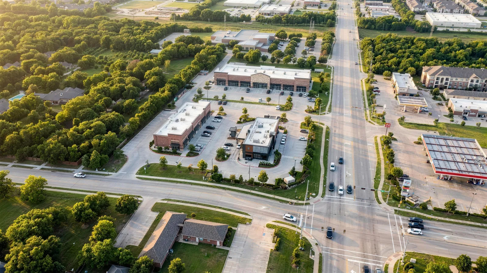 Photorealistic conceptual aerial rendering of a full build-out of the S. Cooper Street pad sites at golden hour
